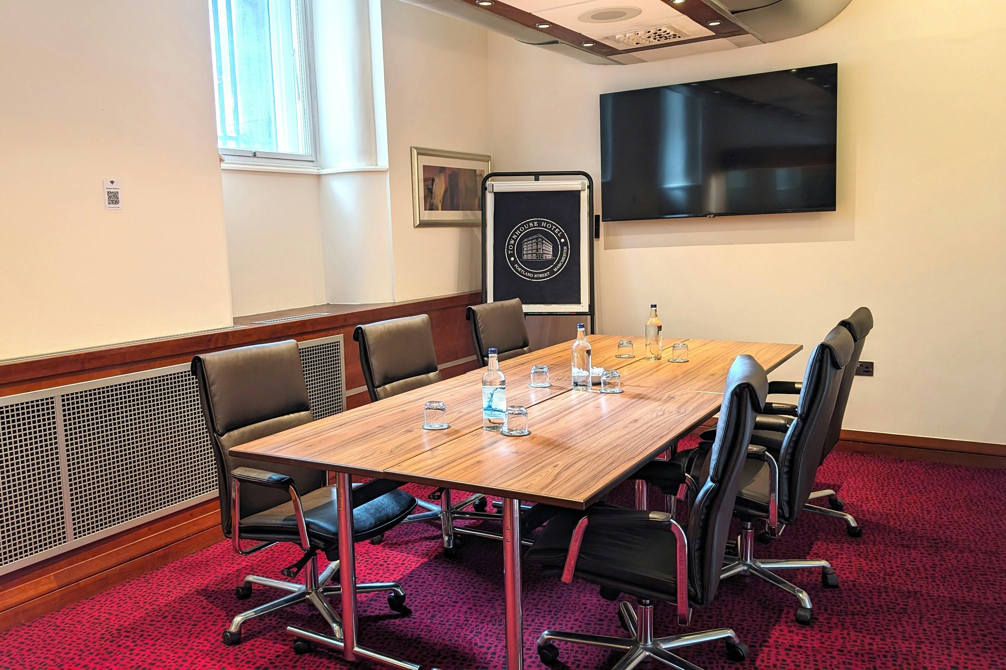 Princess Room at Townhouse Hotel Manchester, featuring a sleek wooden table for meetings.