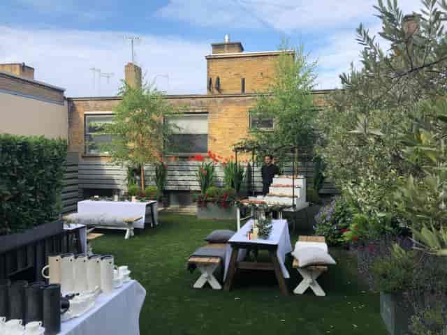 Rooftop event, lush greenery, intimate gathering, garden party