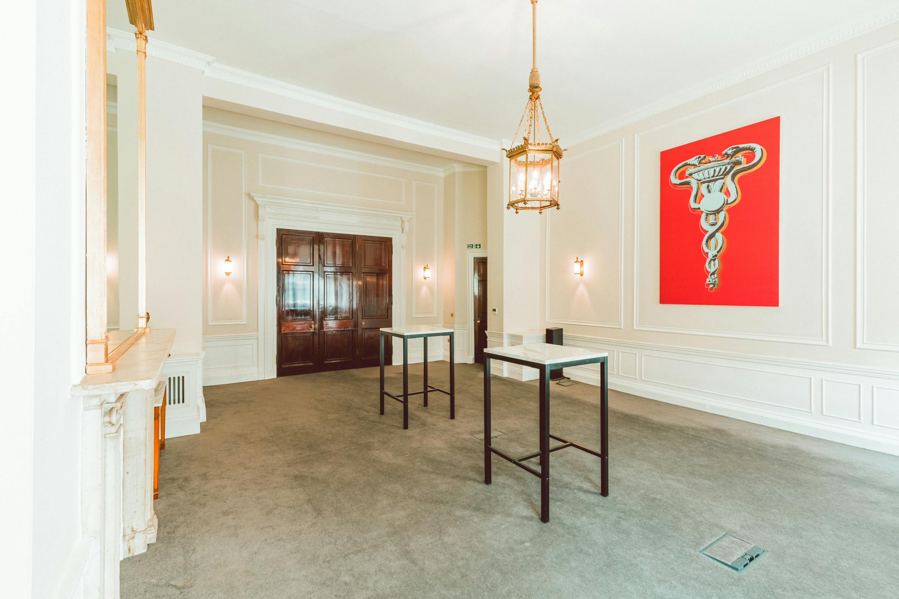 Laurie Landeau in elegant meeting room with red artwork, ideal for networking events.