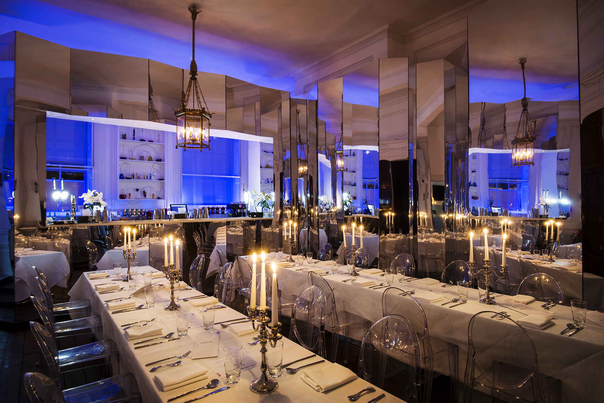 Laurie Landeau in elegant event space with blue lighting for upscale dinners and corporate events. - Banner