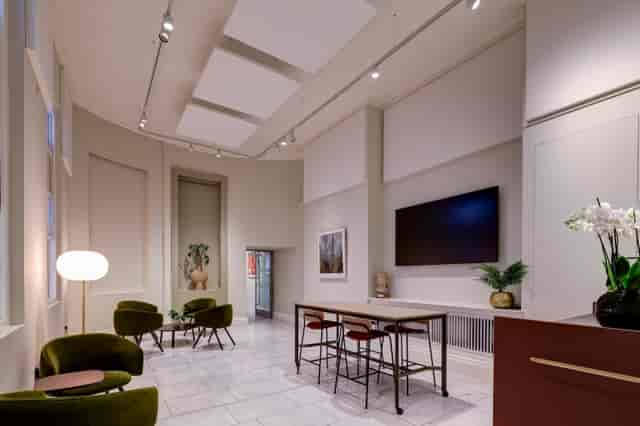 Exhibition space with modern seating & large screen, event venue