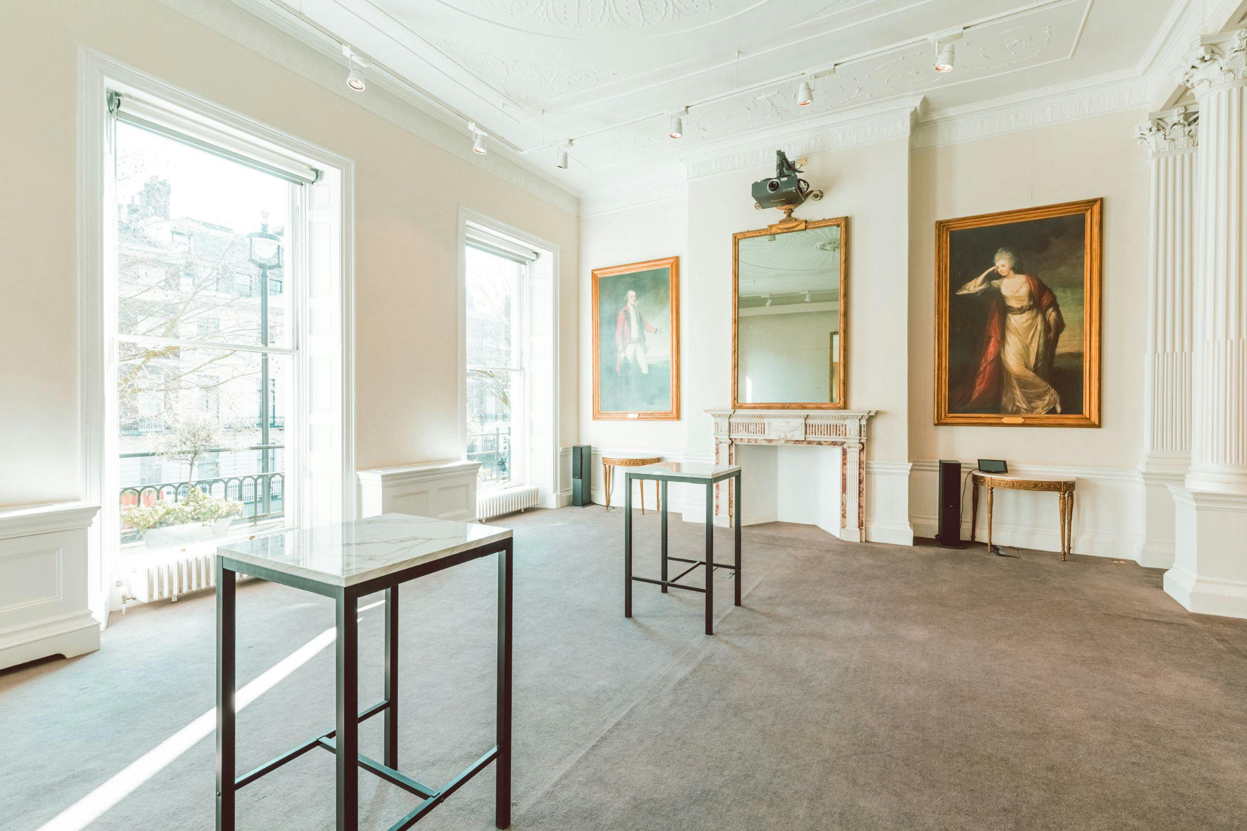 Spacious event space with large windows, ideal for art exhibitions and gatherings.