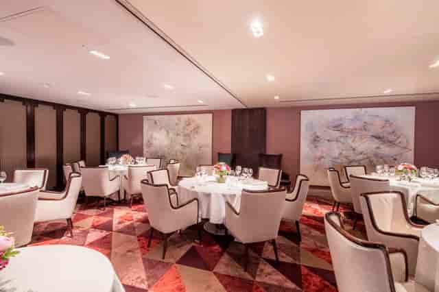 Elegant private dining room with floral centerpieces for upscale events and corporate gatherings.