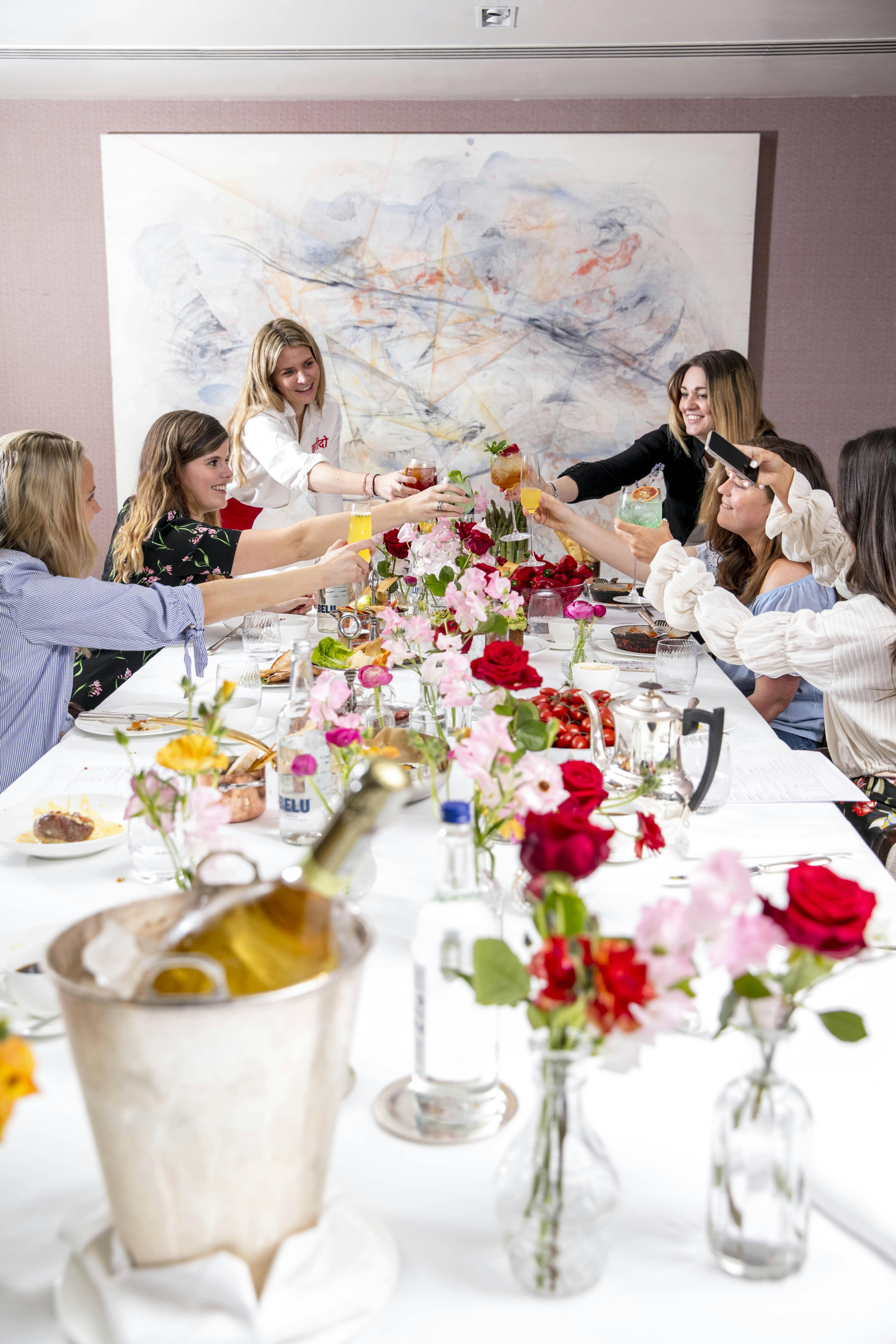 Women toasting at a vibrant private dining room, perfect for celebrations and networking events.