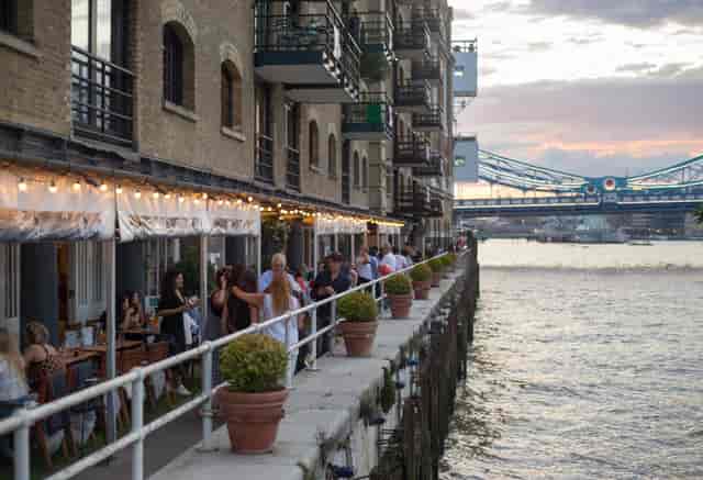 Vibrant waterfront venue at Butlers Wharf, ideal for events with lush greenery and charm.