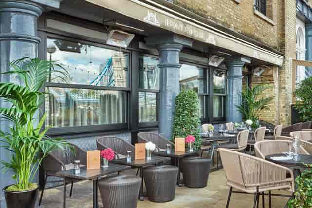 Stylish outdoor dining area at Le Pont de la Tour, ideal for networking events.