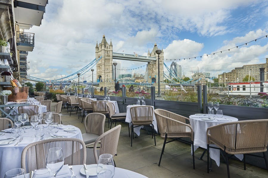 Outdoor dining at Le Pont de la Tour with Tower Bridge view, perfect for upscale events.