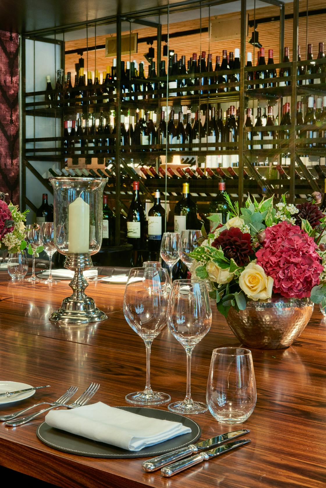 Elegant dining table with floral centerpieces for upscale events and wine tastings.