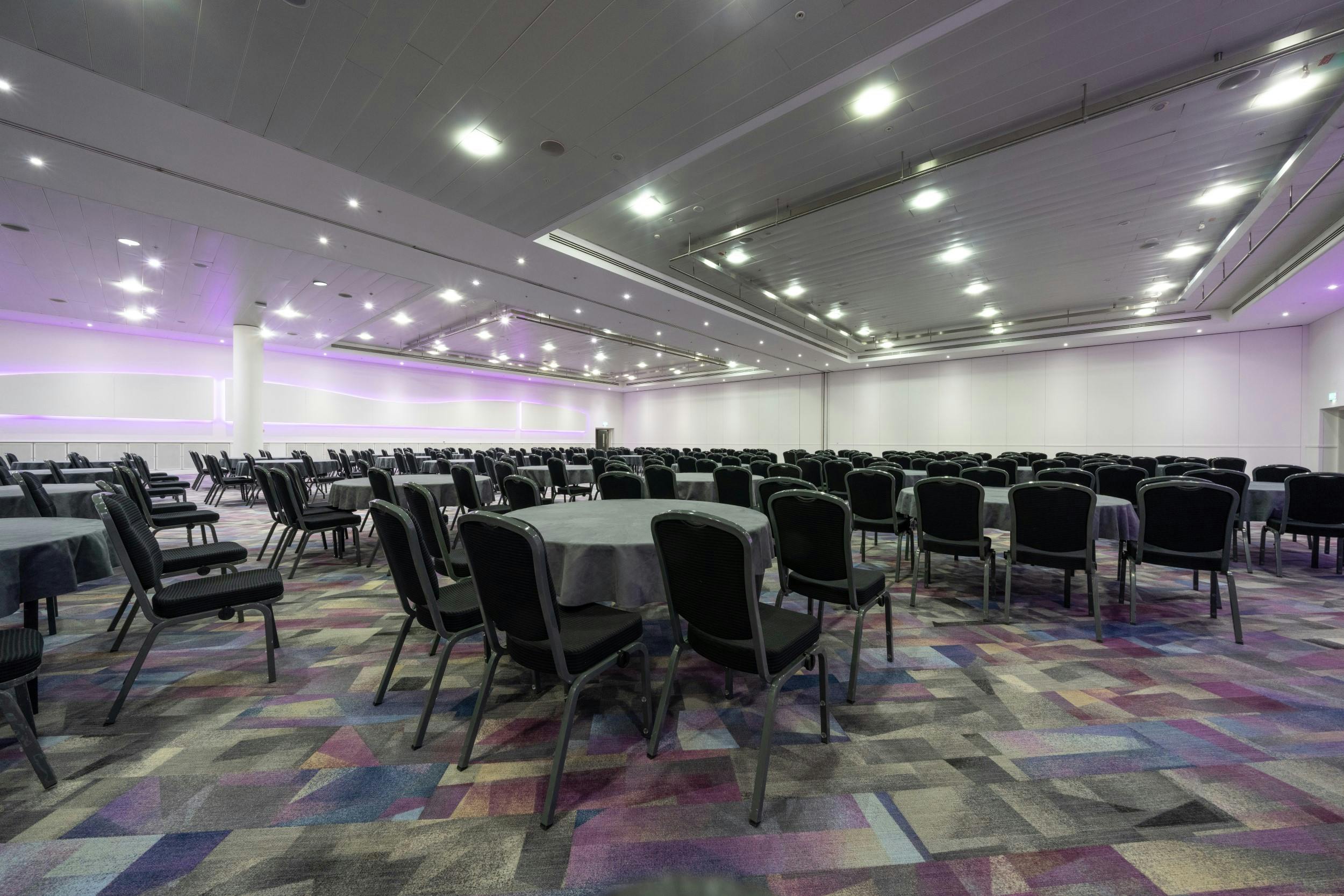 Platinum Suite at ExCeL London, modern event venue with round tables for gatherings.