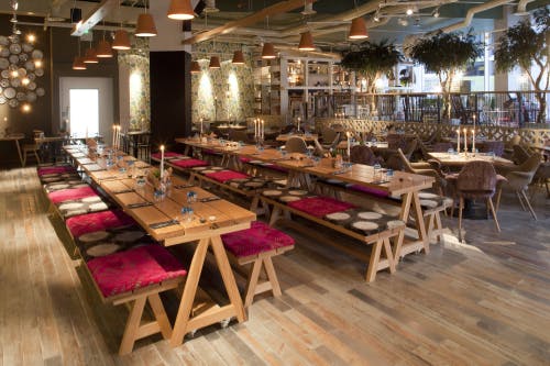 Private dining room at The Folly Bar with wooden tables, ideal for events and gatherings.
