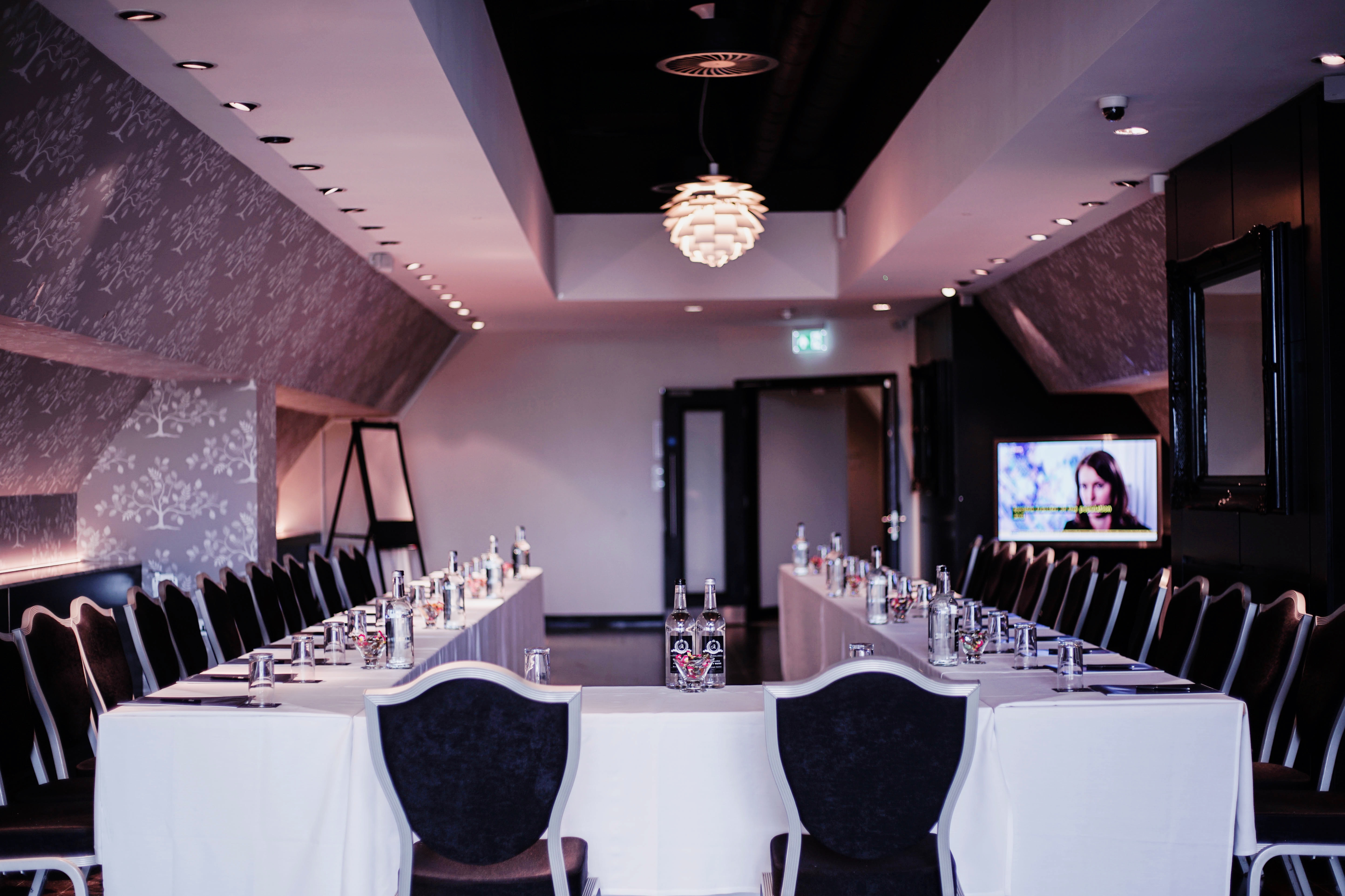Corporate meeting room at The Clubhouse, Hilton London Syon Park, elegant setup for events. - Banner