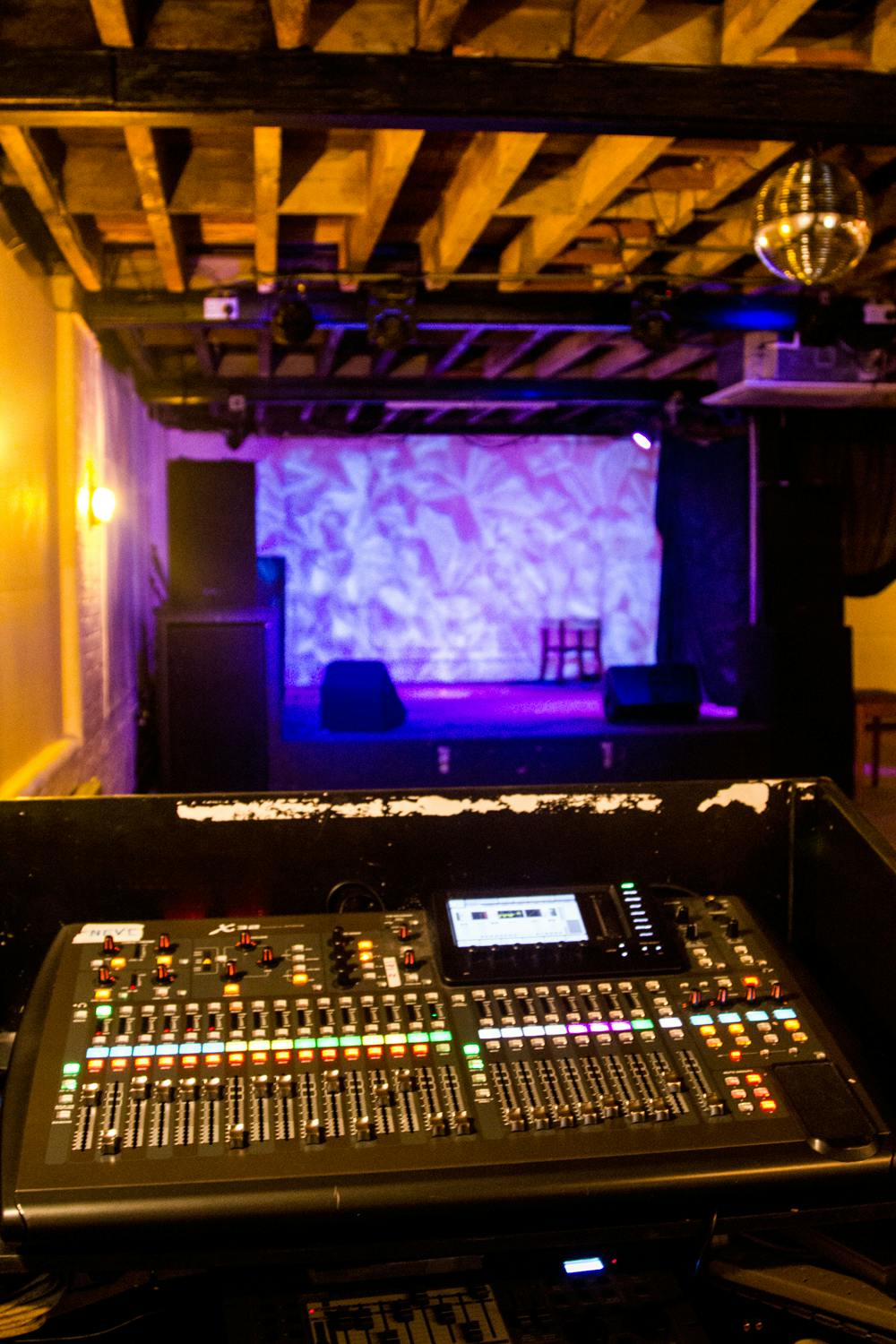 Versatile Kraak Gallery event space with sound console and ambient lighting for performances.