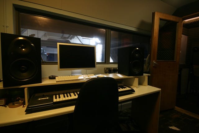 Recording studio at The Harrow Club with soundproofing for music workshops and sessions.