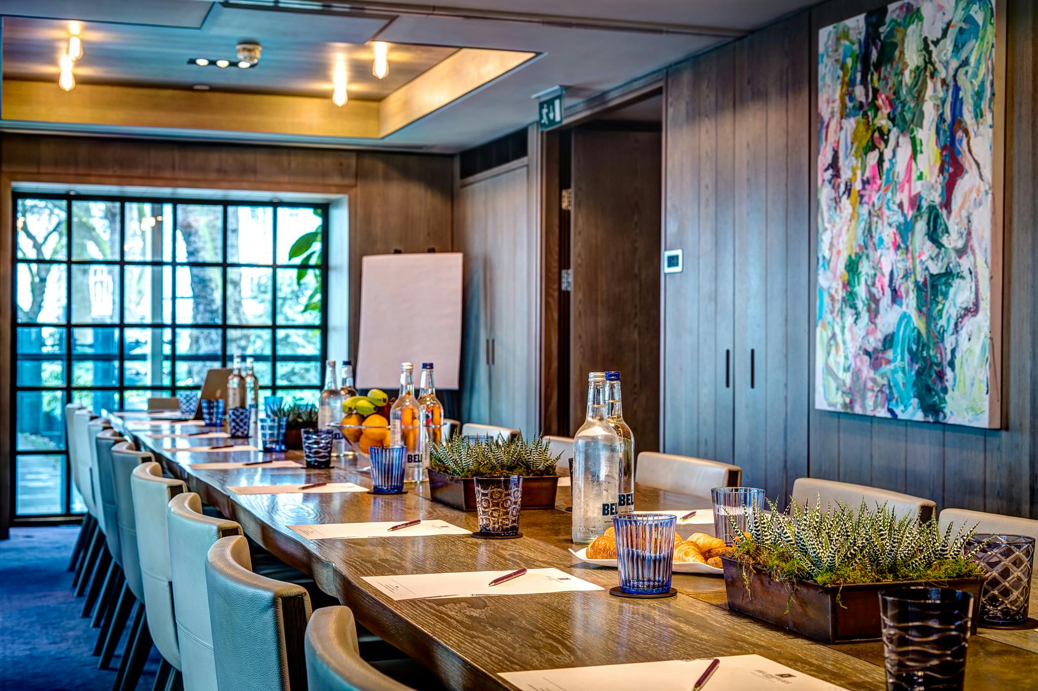 Meeting room at The Muse in The Hari, featuring a long table and natural light for collaboration.