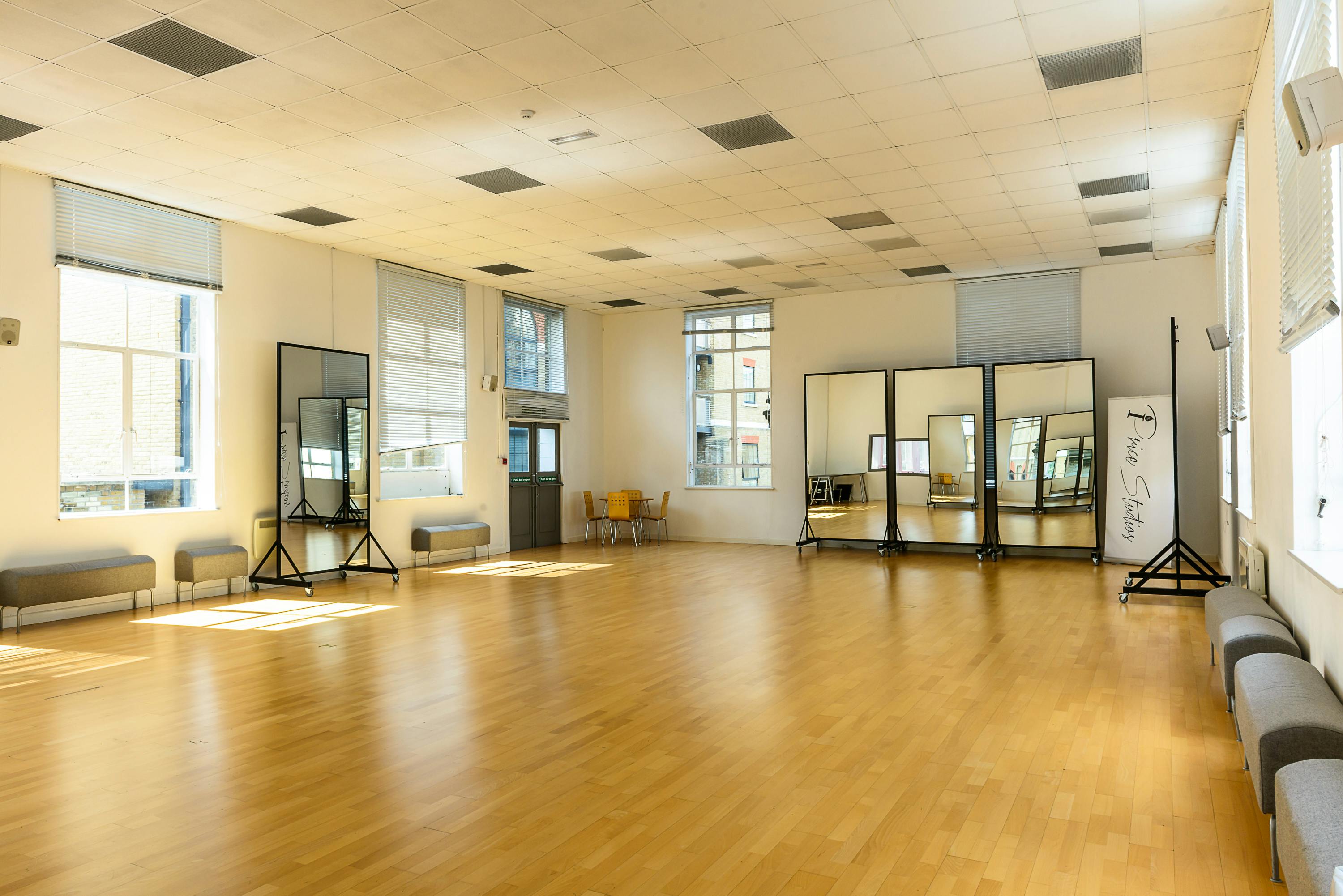 Spacious event space with hardwood floors, ideal for dance classes and workshops.