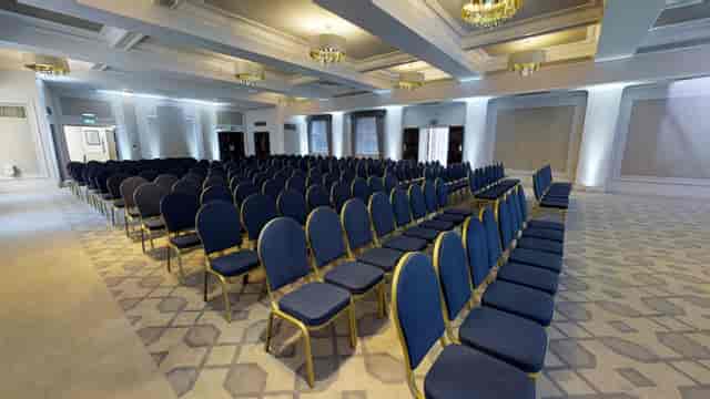 Crown & Cornwall Suite conference room with blue chairs, ideal for presentations and seminars.