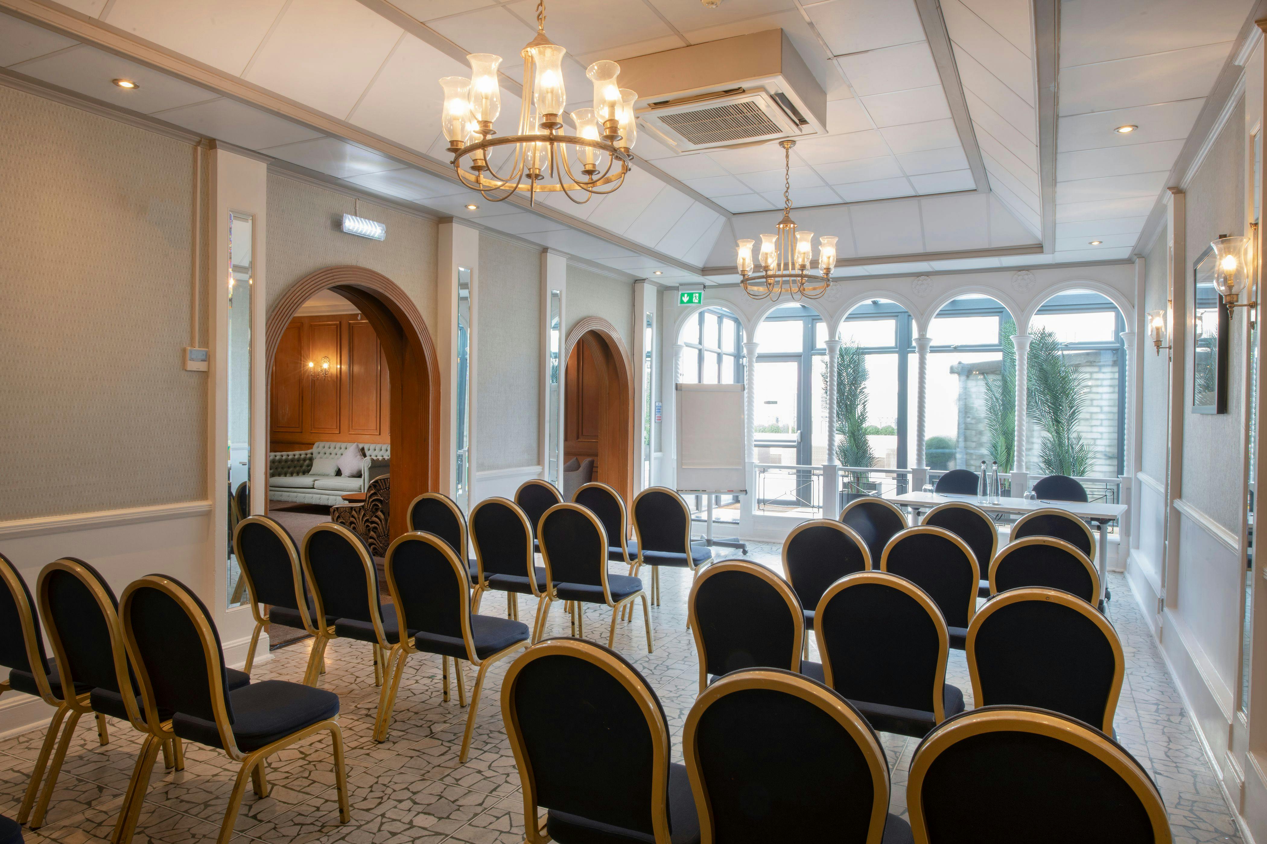 Penthouse meeting room with elegant decor, perfect for workshops and small conferences.