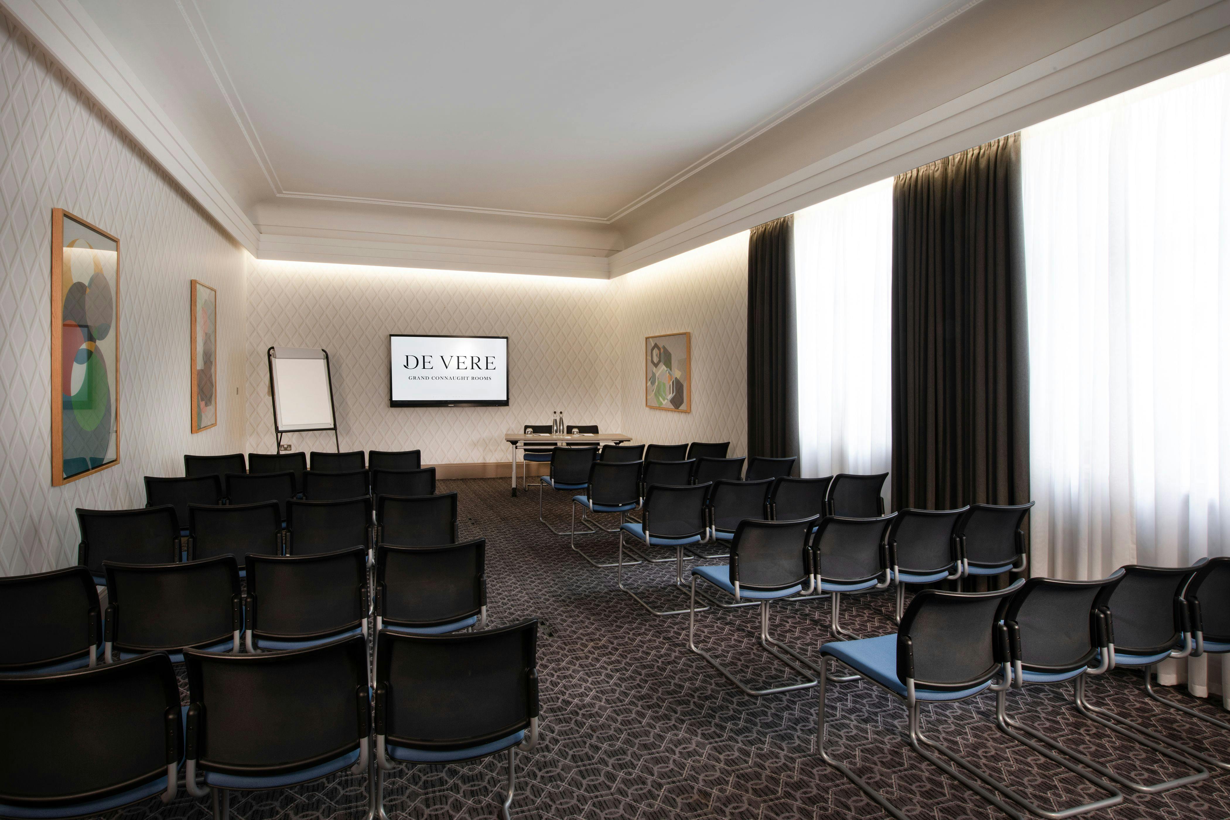 Cambridge Suite meeting room with modern chairs, ideal for corporate events and presentations.