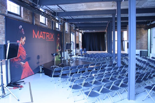 Event space with sleek stage setup, ideal for conferences and product launches.