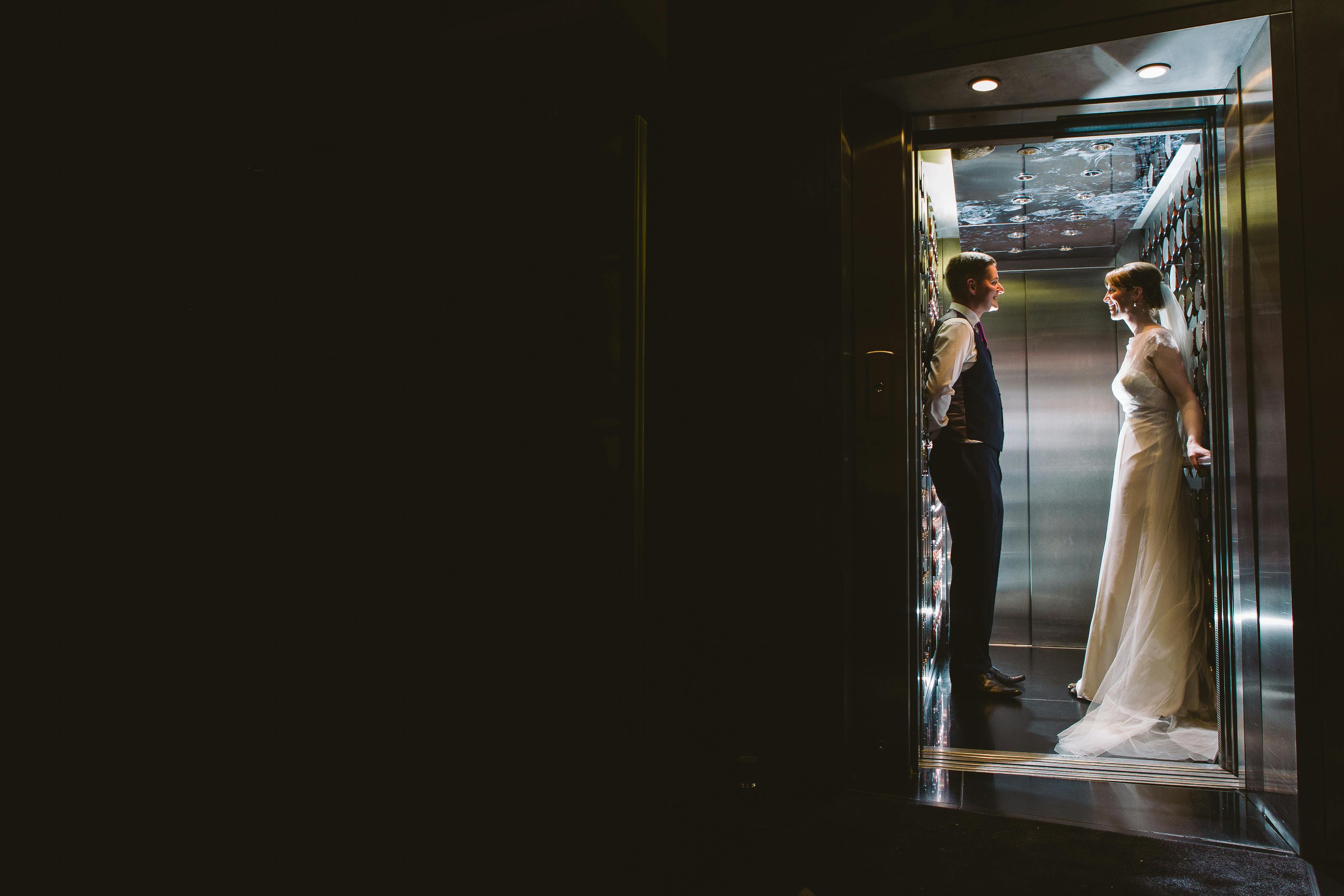 Couple in elevator at The Second Floor Bar & Brasserie, unique event venue ambiance.