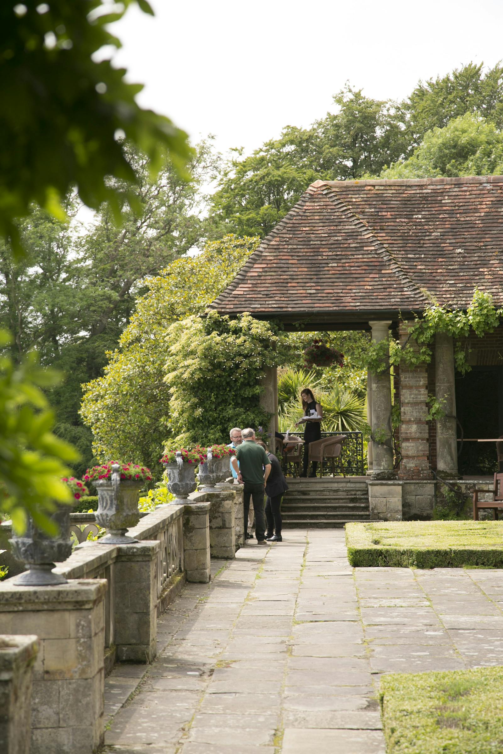 Outdoor wedding venue at Port Lympne Hotel with lush greenery and elegant architecture.