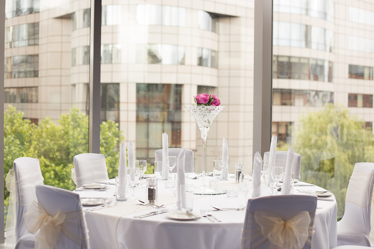 Elegant round table setup with floral arrangements in Bridgewater Hall for weddings or corporate events. - Banner