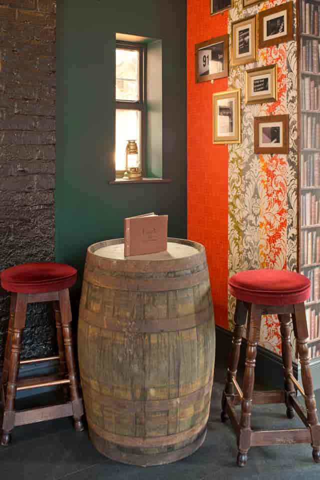 Cozy Lounge Bar & Terrace with rustic barrel table, ideal for networking events.