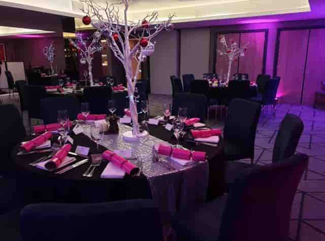 Festive gala ballroom with LED lighting and sequined decor for corporate holiday events.
