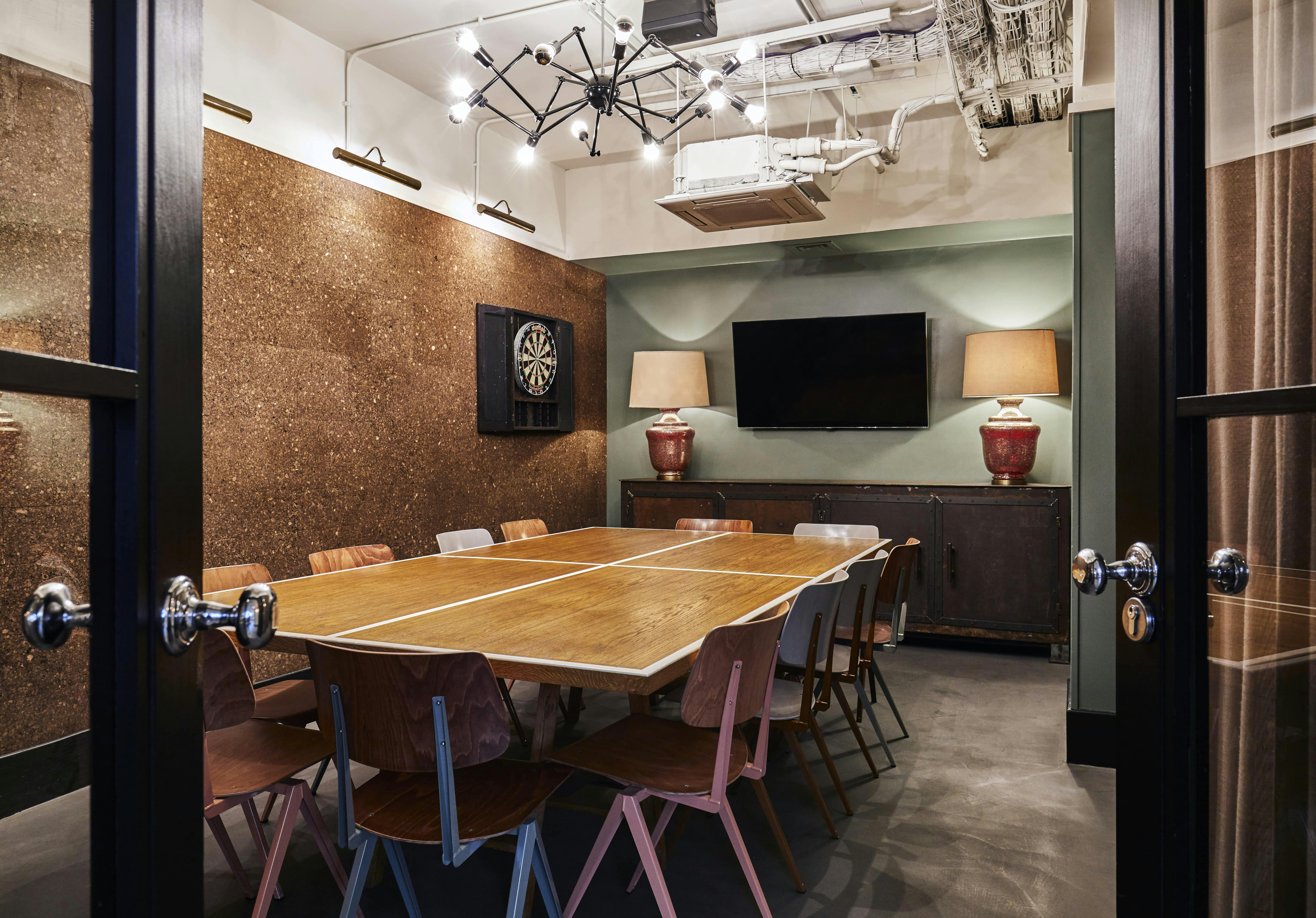 Modern meeting room in The Hoxton Shoreditch with wooden table, ideal for collaboration.