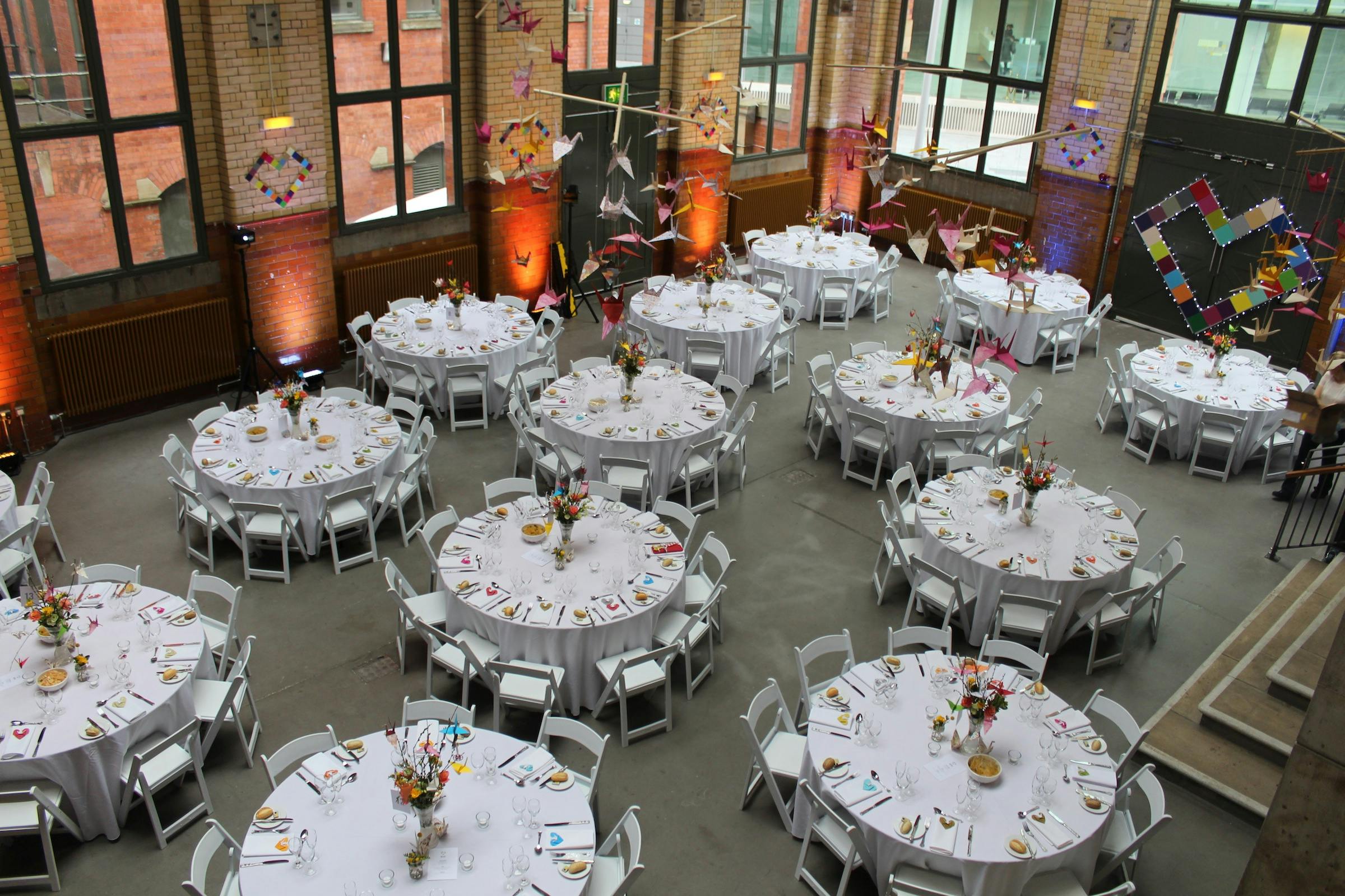 Engine Hall event space with elegant round tables, ideal for networking and celebrations.