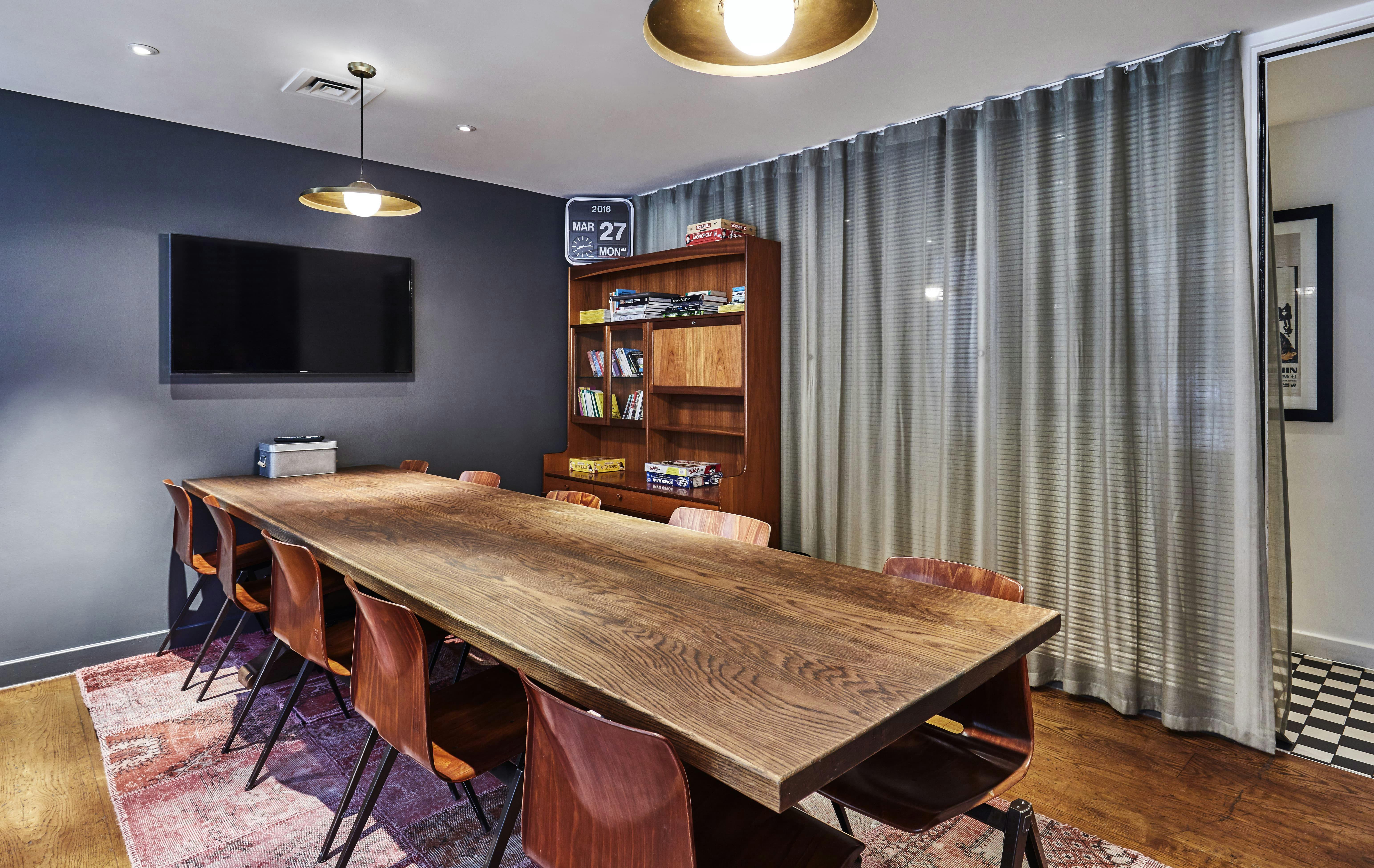 Modern meeting room with wooden table, ideal for collaborative events at The Hoxton Shoreditch.