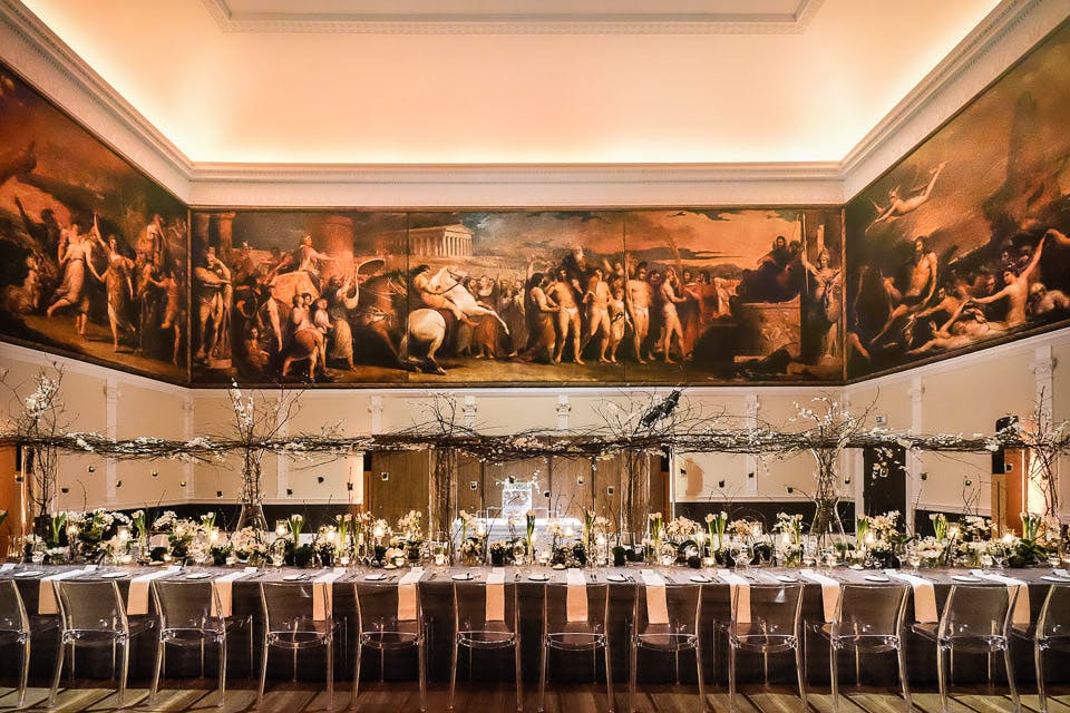 Elegant event space in RSA House with a long table and stunning mural for weddings.