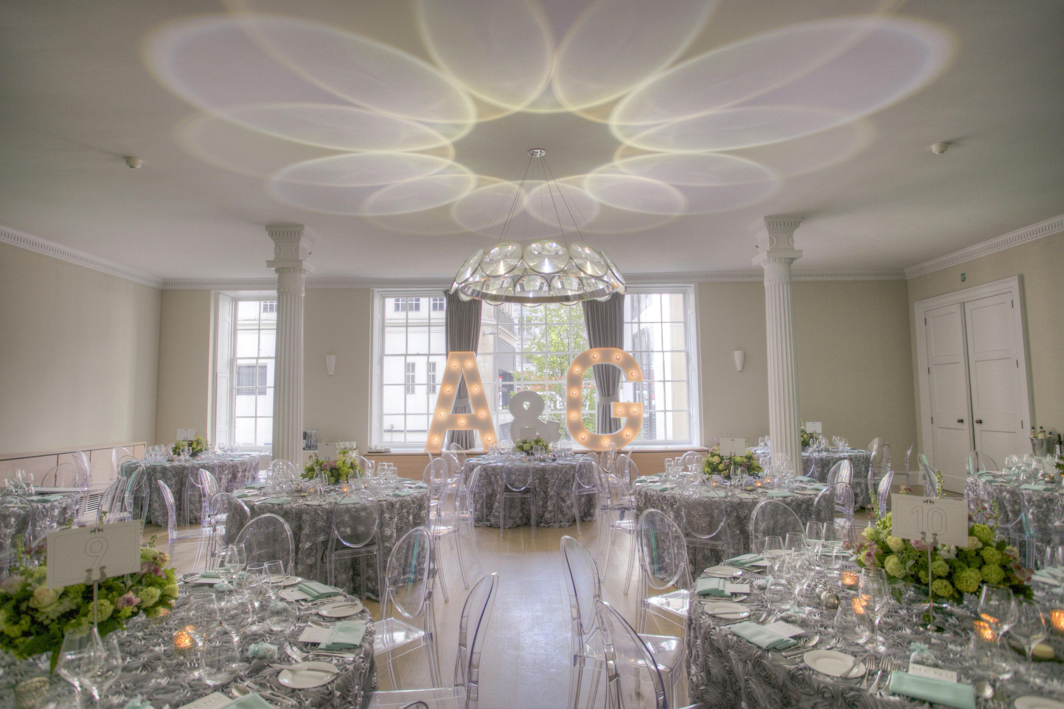 Elegant event space in The Benjamin Franklin Room with floral centerpieces, ideal for weddings.