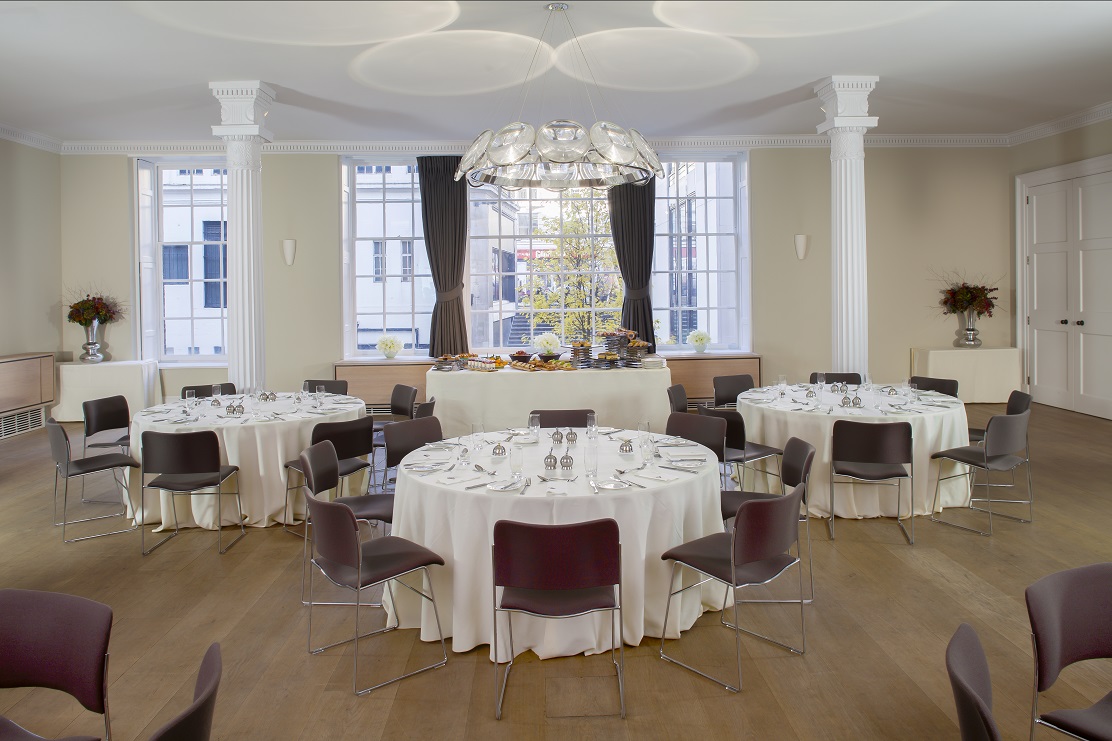 Elegant Benjamin Franklin Room set for formal corporate event with natural light. - Banner