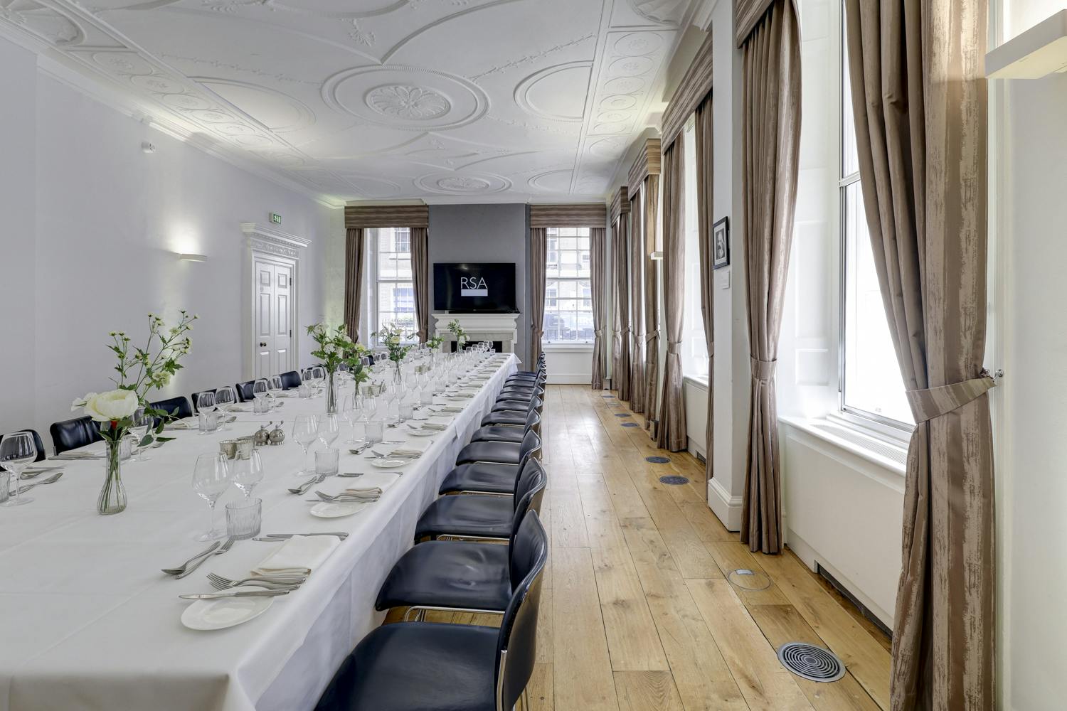 Elegant meeting room with floral centerpieces, perfect for events and gatherings.