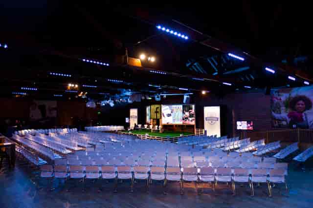 Event space at The Porter Tun with spacious seating and large screens for presentations.