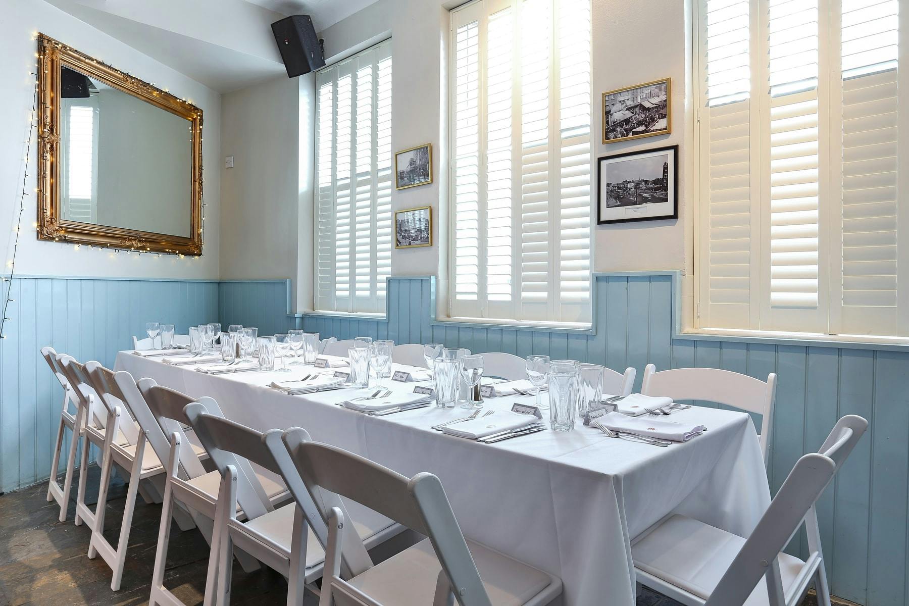 Elegant dining setup in The Saloon, ideal for intimate meetings and events.