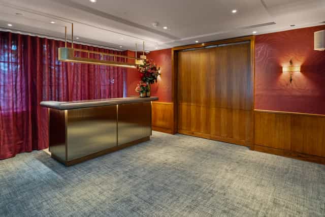 Beaufort Room at Bluebird Chelsea: elegant event space with rich red drapery for corporate meetings.