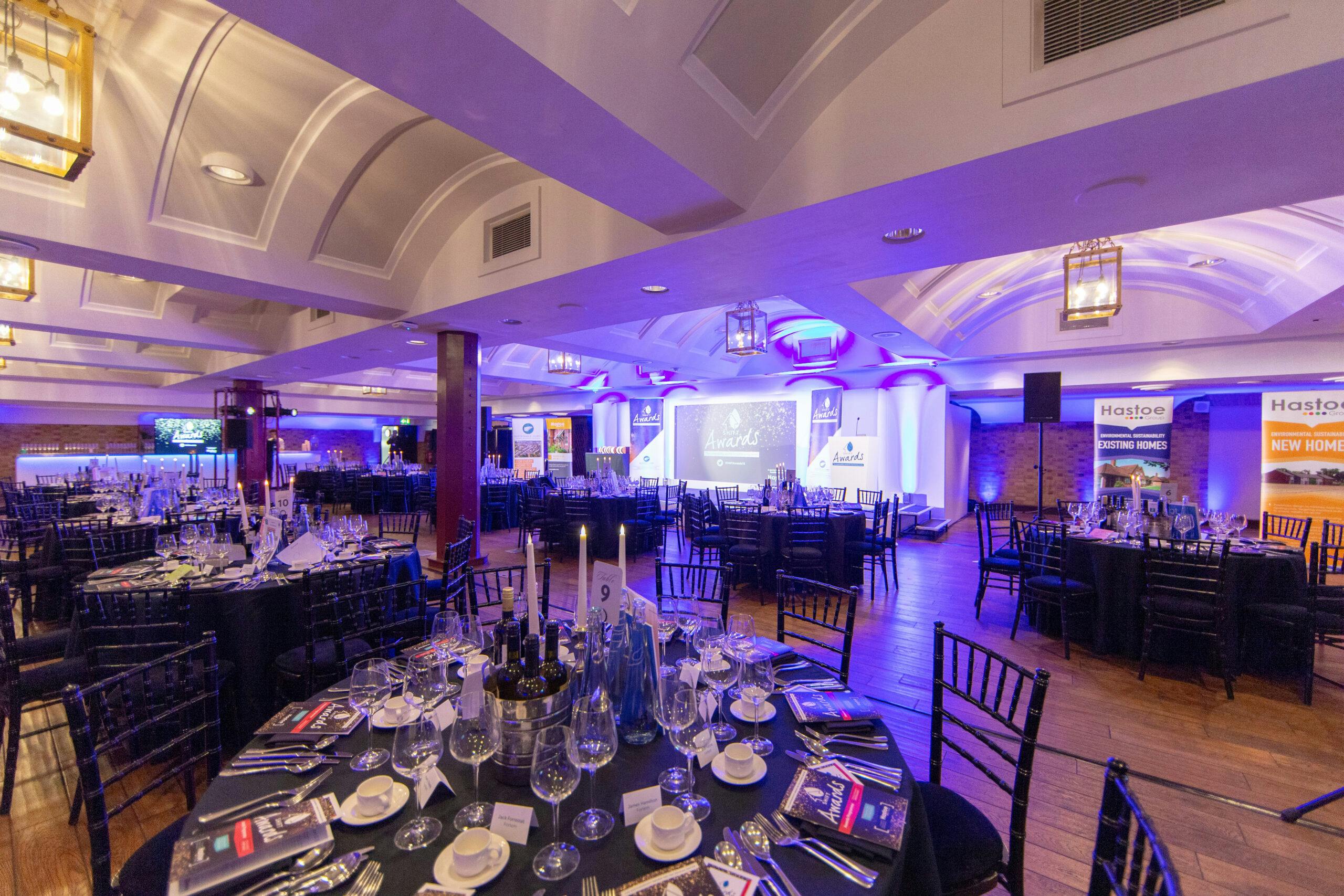 Elegant formal dinner setup at The King George III, featuring black linens and ambient lighting.