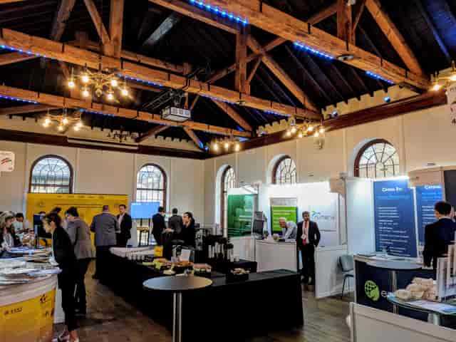 Vibrant exhibition space with high wooden ceilings for networking and branding events.