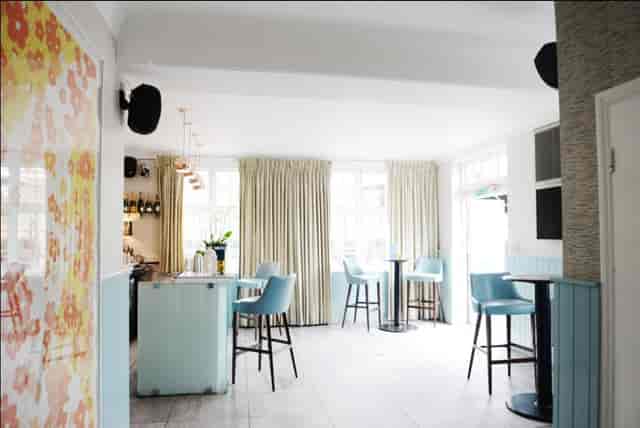 Bright event space in The Chapel Bar with modern decor, ideal for gatherings and networking.