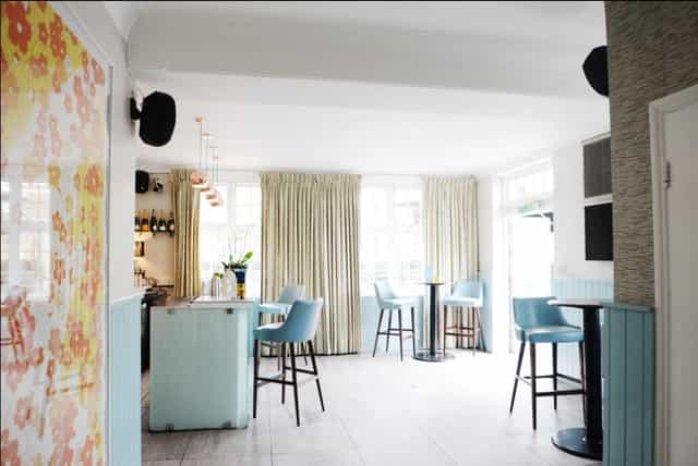 Bright event space in The Chapel Bar with modern decor, ideal for gatherings and networking.