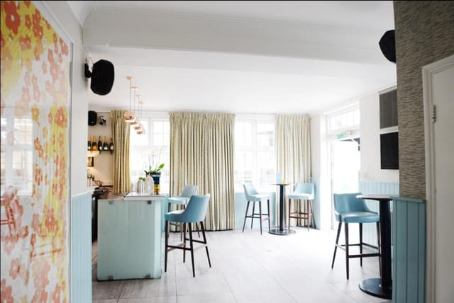 Bright event space in The Chapel Bar with modern decor, ideal for gatherings and networking.