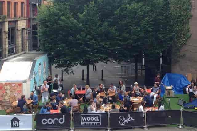 Vibrant outdoor event space in Tib Street Garden for casual gatherings and networking.