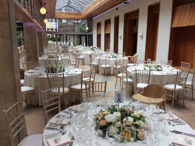 Elegant banquet space with floral centerpieces for weddings and corporate events.