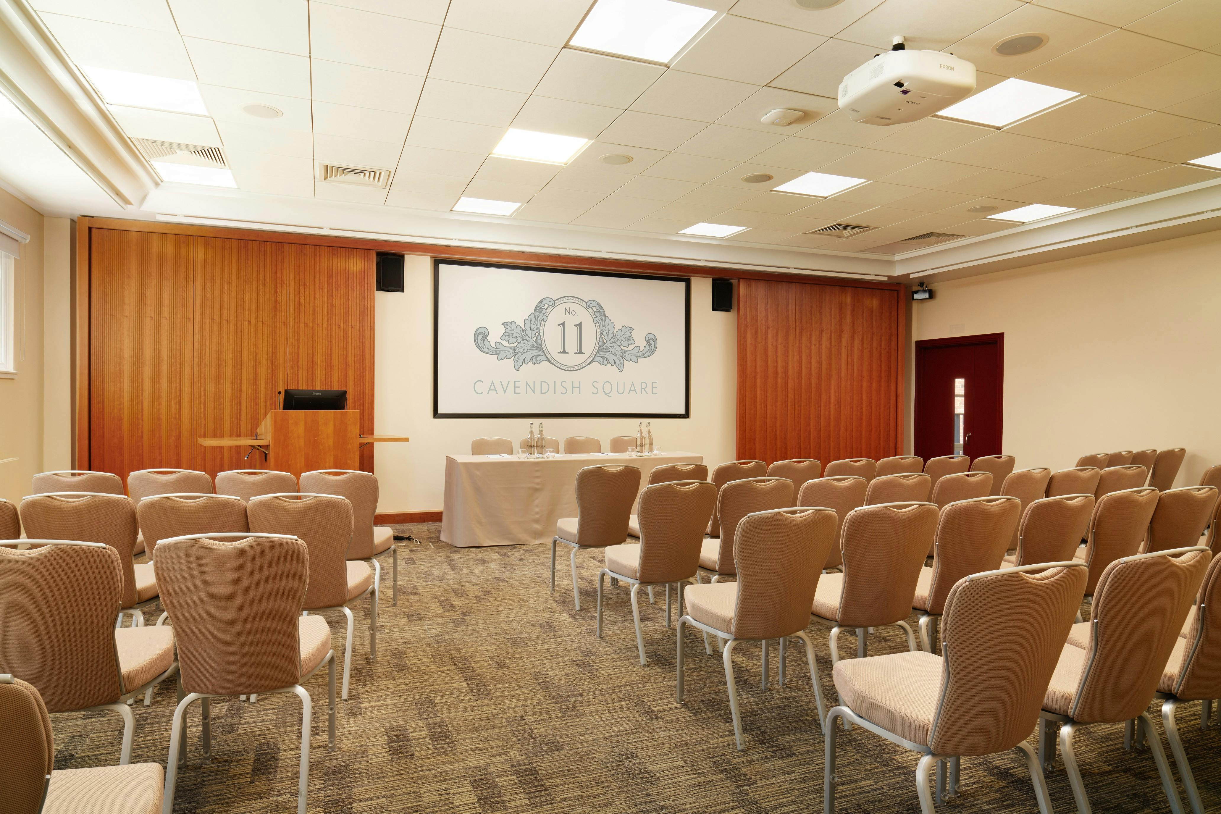 Marlborough Theatre meeting room with beige chairs, ideal for presentations and workshops.