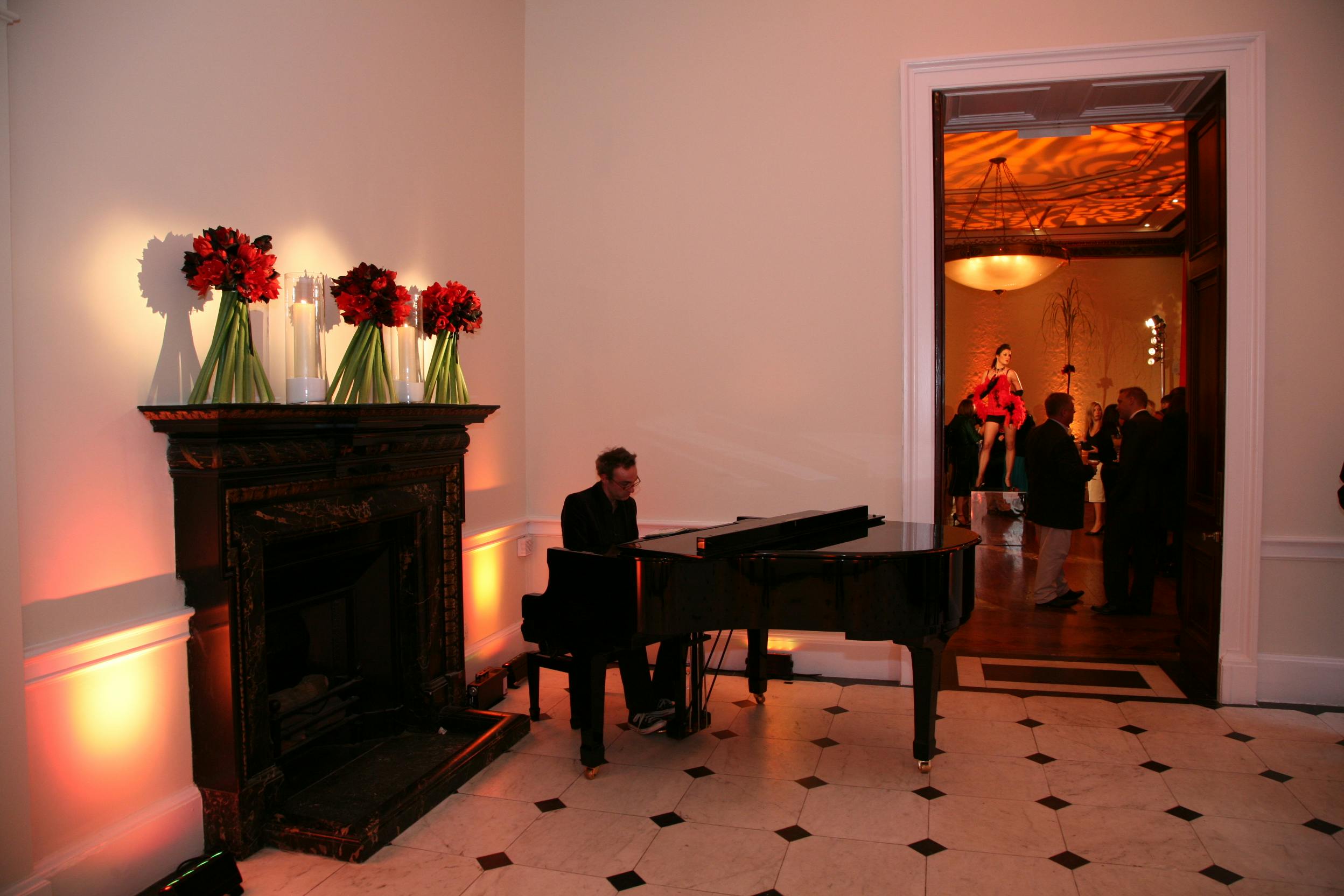Elegant Marble Hall event with pianist, floral decor, and inviting ambiance.