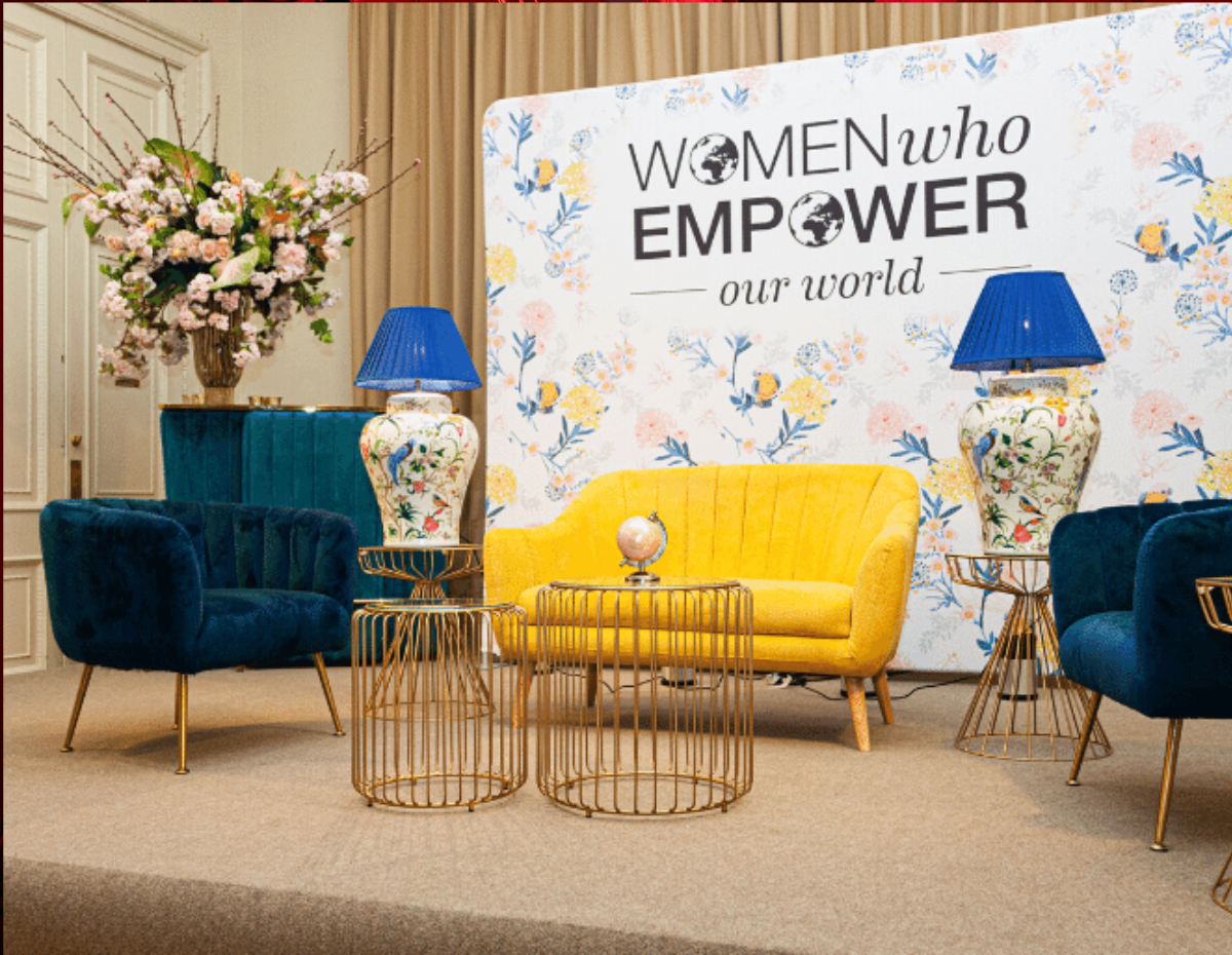 Stylish event setup at Kent House with vibrant seating and floral backdrop for networking.