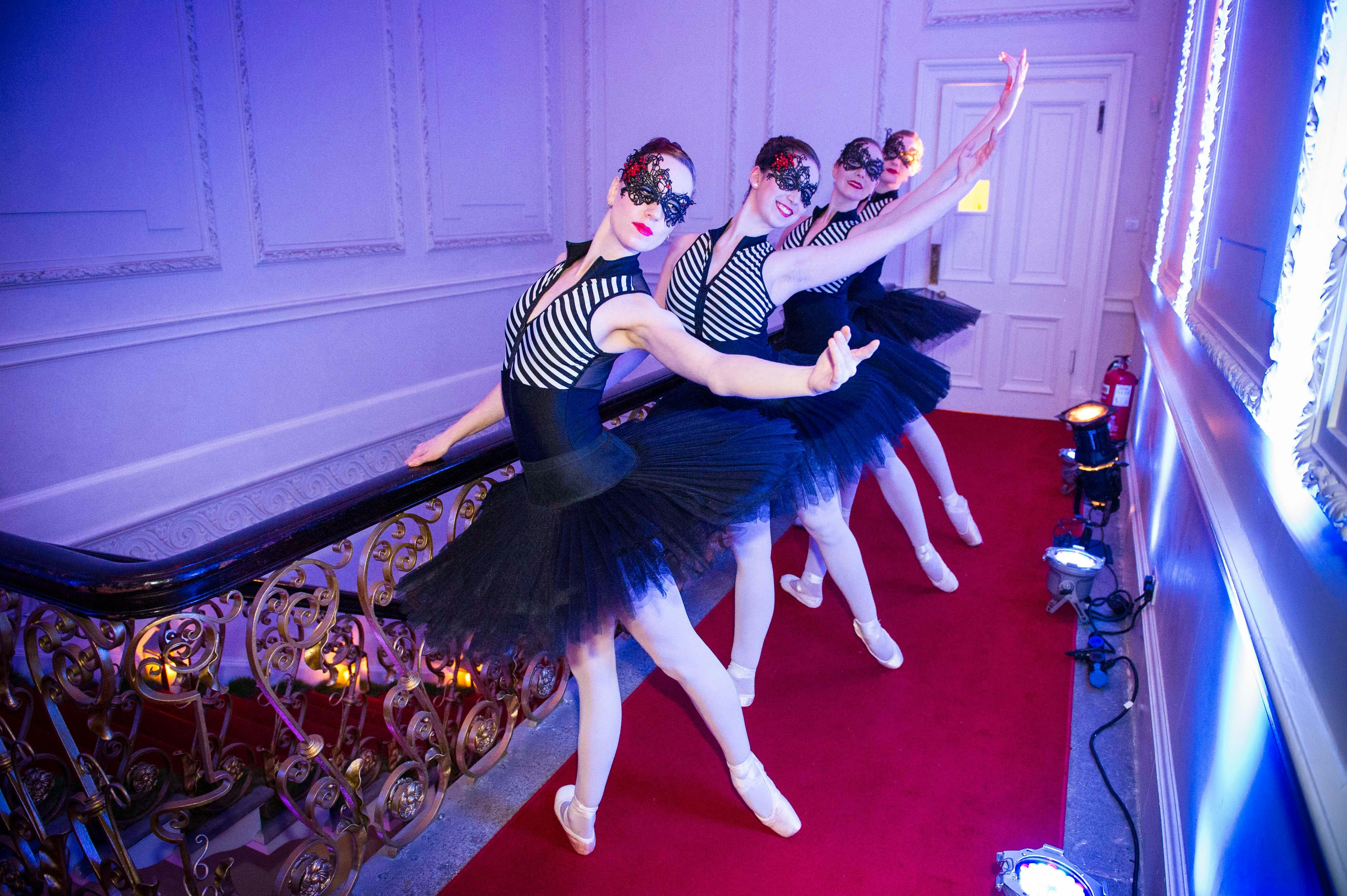 Dancers in elegant costumes at upscale Kent House Knightsbridge event.