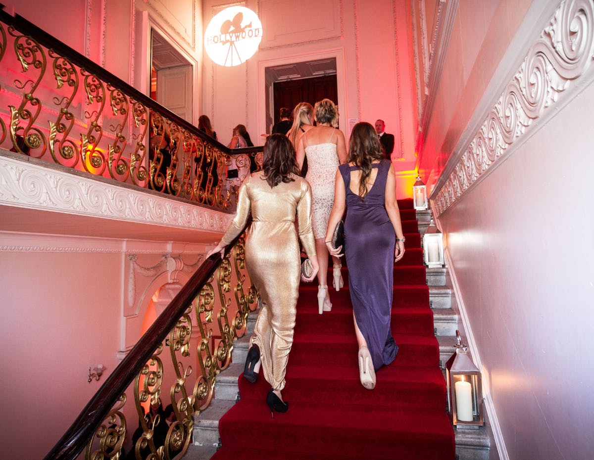 Elegant event at Kent House Knightsbridge with guests on grand staircase, perfect for celebrations.
